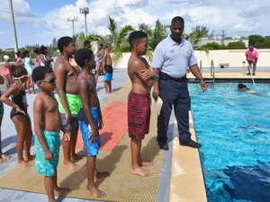 PFA President standing at the edge of a pool giving instruction